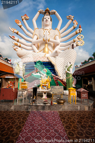 Image of Eighteen arms Buddha over blue sky