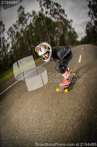 Image of Downhill skateboarder in action