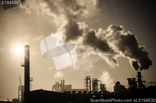 Image of Smoking chimney  at sunset 