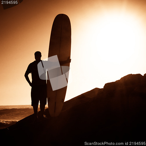 Image of Long boarder watching the waves