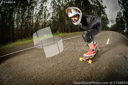 Image of Downhill skateboarder in action