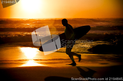 Image of Surfer running