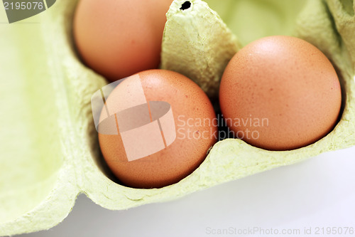 Image of Fresh brown eggs in a carton