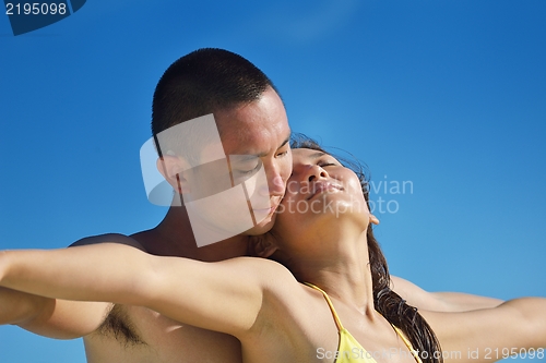 Image of happy young  couple enjoying summer on beach
