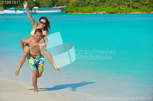 Image of happy young  couple enjoying summer on beach