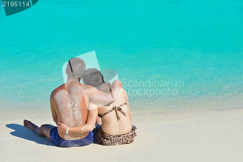 Image of happy young  couple enjoying summer on beach