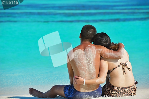 Image of happy young  couple enjoying summer on beach