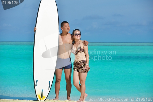 Image of happy young  couple enjoying summer on beach