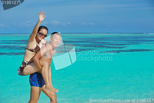 Image of happy young  couple enjoying summer on beach