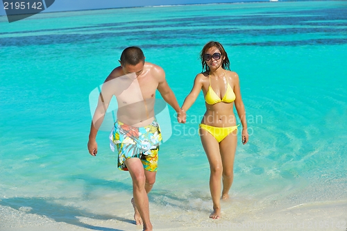 Image of happy young  couple enjoying summer on beach