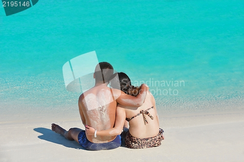 Image of happy young  couple enjoying summer on beach