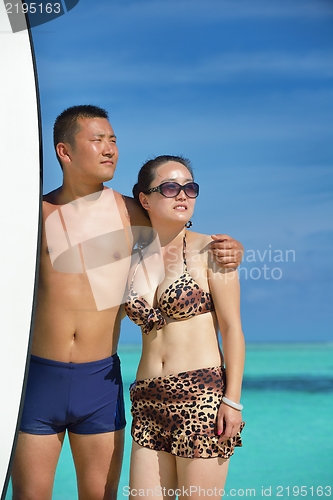 Image of happy young  couple enjoying summer on beach