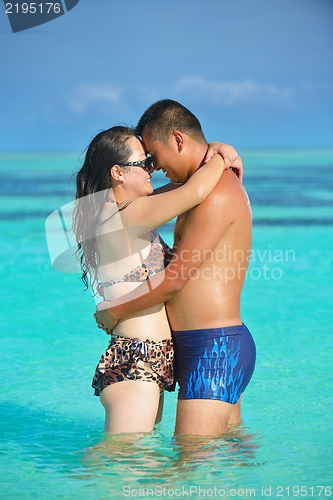 Image of happy young  couple enjoying summer on beach