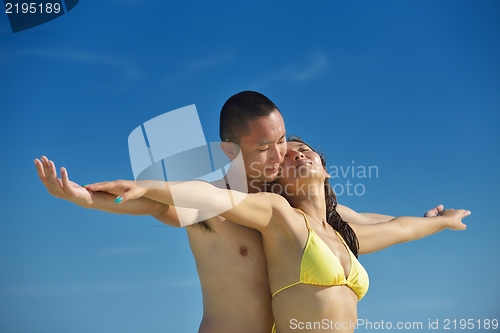 Image of happy young  couple enjoying summer on beach