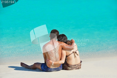 Image of happy young  couple enjoying summer on beach