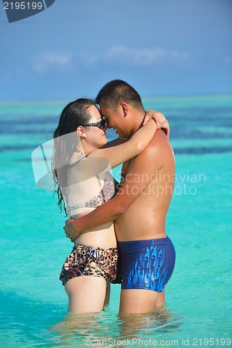 Image of happy young  couple enjoying summer on beach