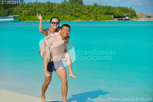 Image of happy young  couple enjoying summer on beach