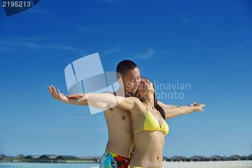 Image of happy young  couple enjoying summer on beach