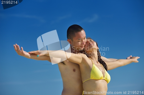 Image of happy young  couple enjoying summer on beach