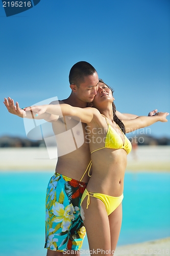 Image of happy young  couple enjoying summer on beach