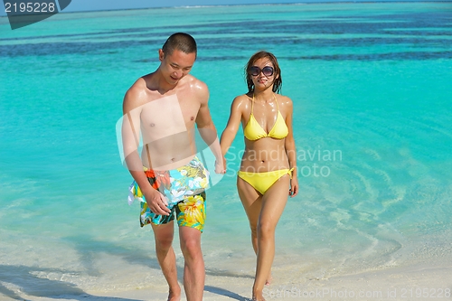 Image of happy young  couple enjoying summer on beach