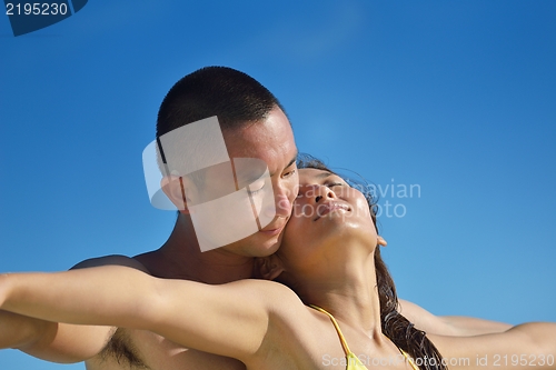 Image of happy young  couple enjoying summer on beach