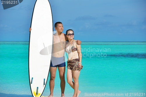 Image of happy young  couple enjoying summer on beach