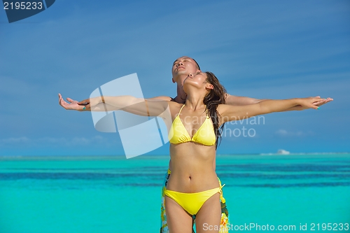 Image of happy young  couple enjoying summer on beach