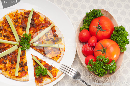 Image of Turkish beef pizza with cucumber on top