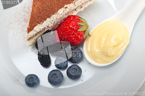 Image of tiramisu dessert with berries and cream