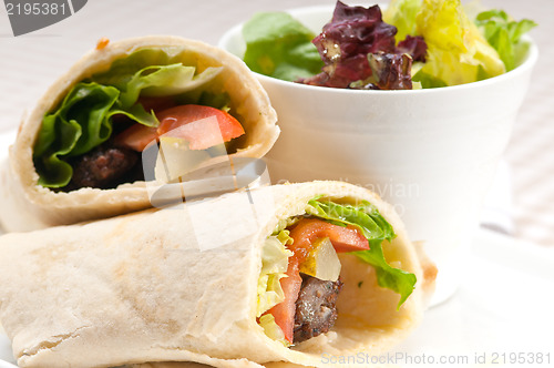 Image of kafta shawarma chicken pita wrap roll sandwich