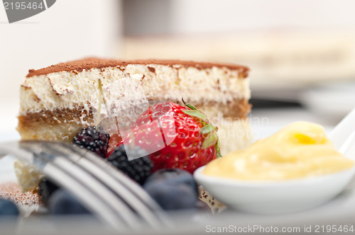 Image of tiramisu dessert with berries and cream