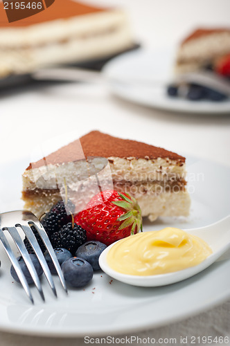 Image of tiramisu dessert with berries and cream