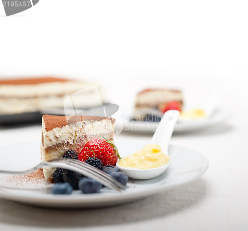 Image of tiramisu dessert with berries and cream