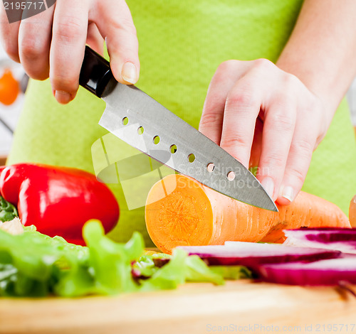 Image of Woman's hands cutting vegetables