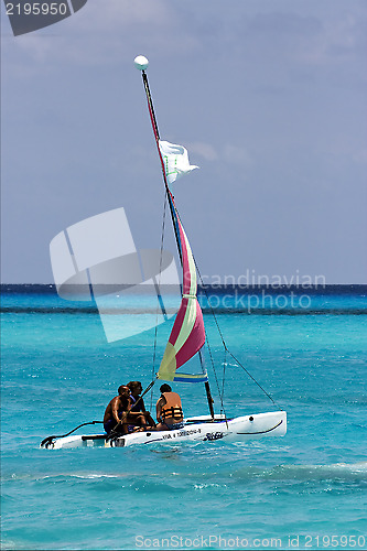 Image of cloudy  catamaran  boat  and coastline in mexico playa del carme