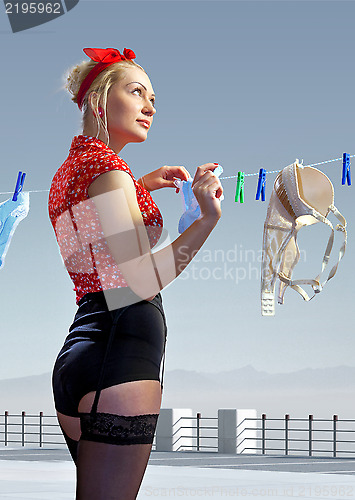 Image of woman hangs out washed underwear