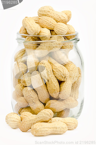 Image of A jar full of unpeeled peanuts on a white background