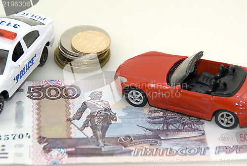 Image of Red toy car, money and documents