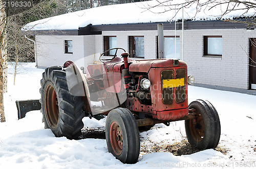 Image of old red tractor on a farm 