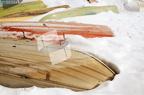 Image of boats in winter under the snow 