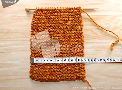 Image of A length of knitting being measured in centimetres