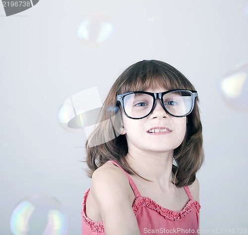 Image of girl playing with soap bubbles