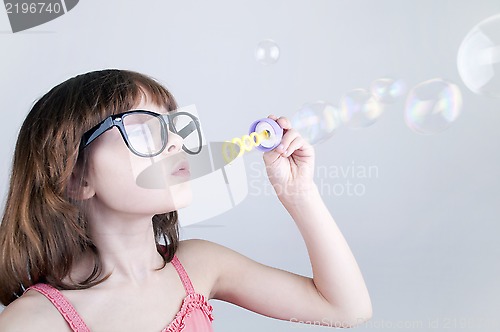 Image of child blowing soap bubbles