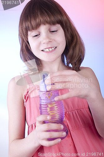 Image of girl blowing soap bubbles