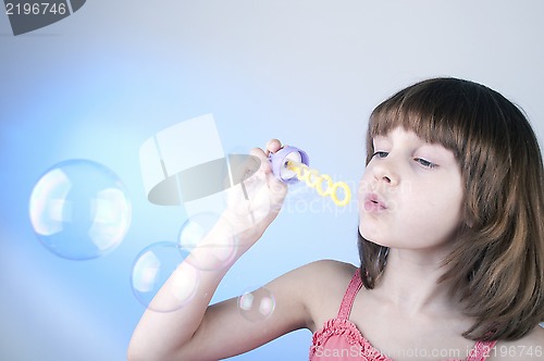 Image of girl blowing soap bubbles