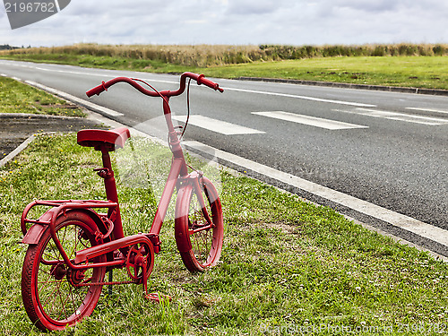 Image of Red Bicycle on the Roadside