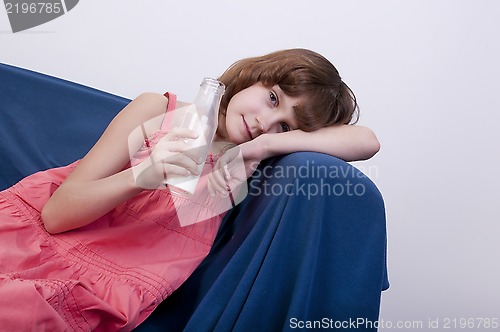 Image of child drinking milk from a glass bottle
