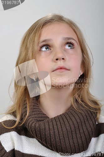 Image of portrait of a elementary girl looking up