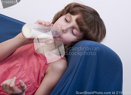 Image of child drinking milk from a glass bottle